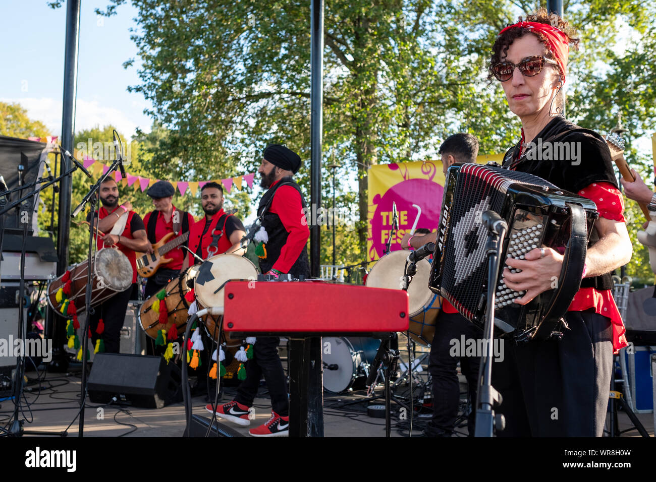 Carol Isaacs on accordion with the Dhol Foundation playing the drums at
